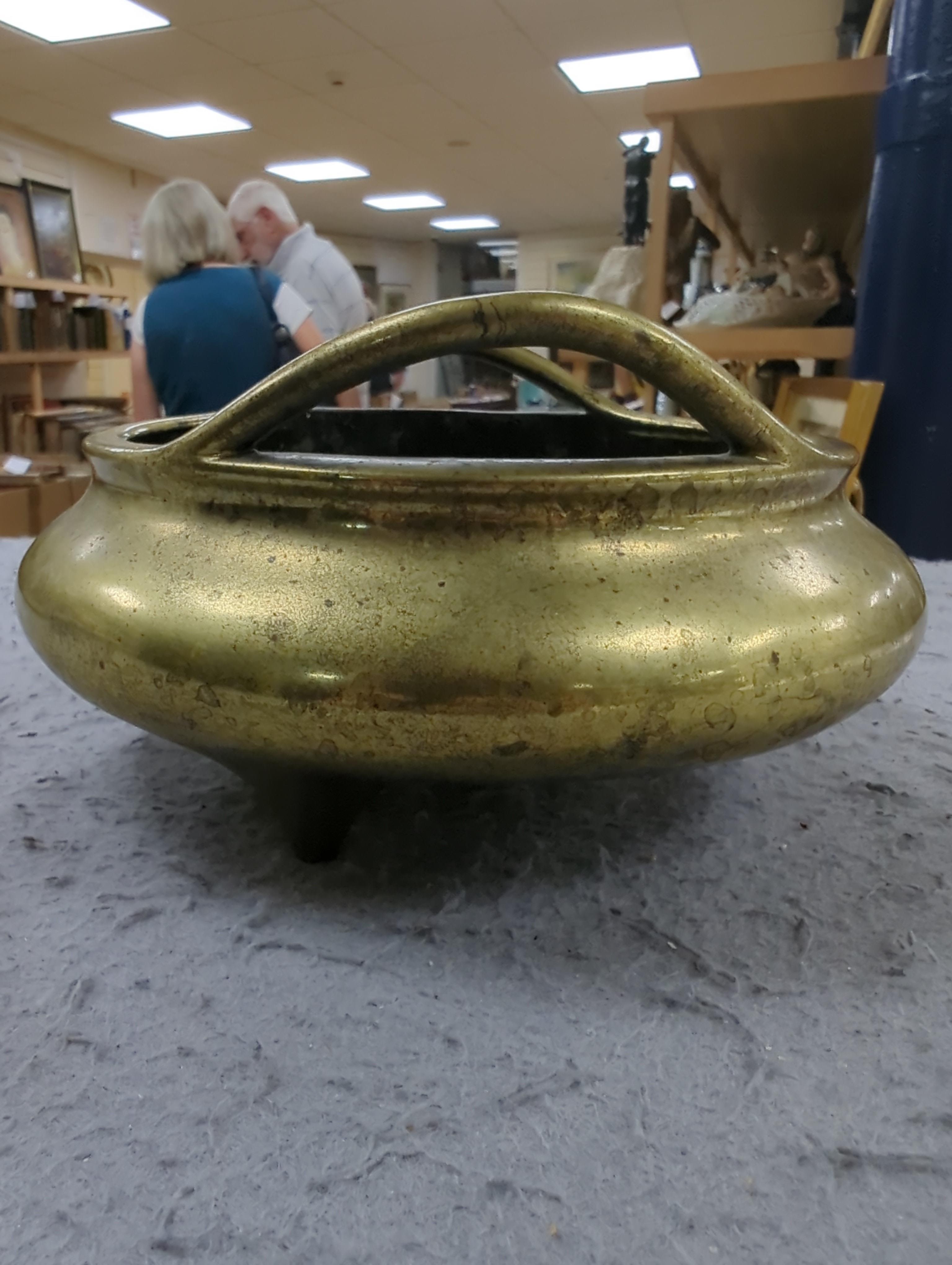 A late 19th century Chinese bronze censer with twin handles, apocryphal Xuande mark, 17.5cm in diameter